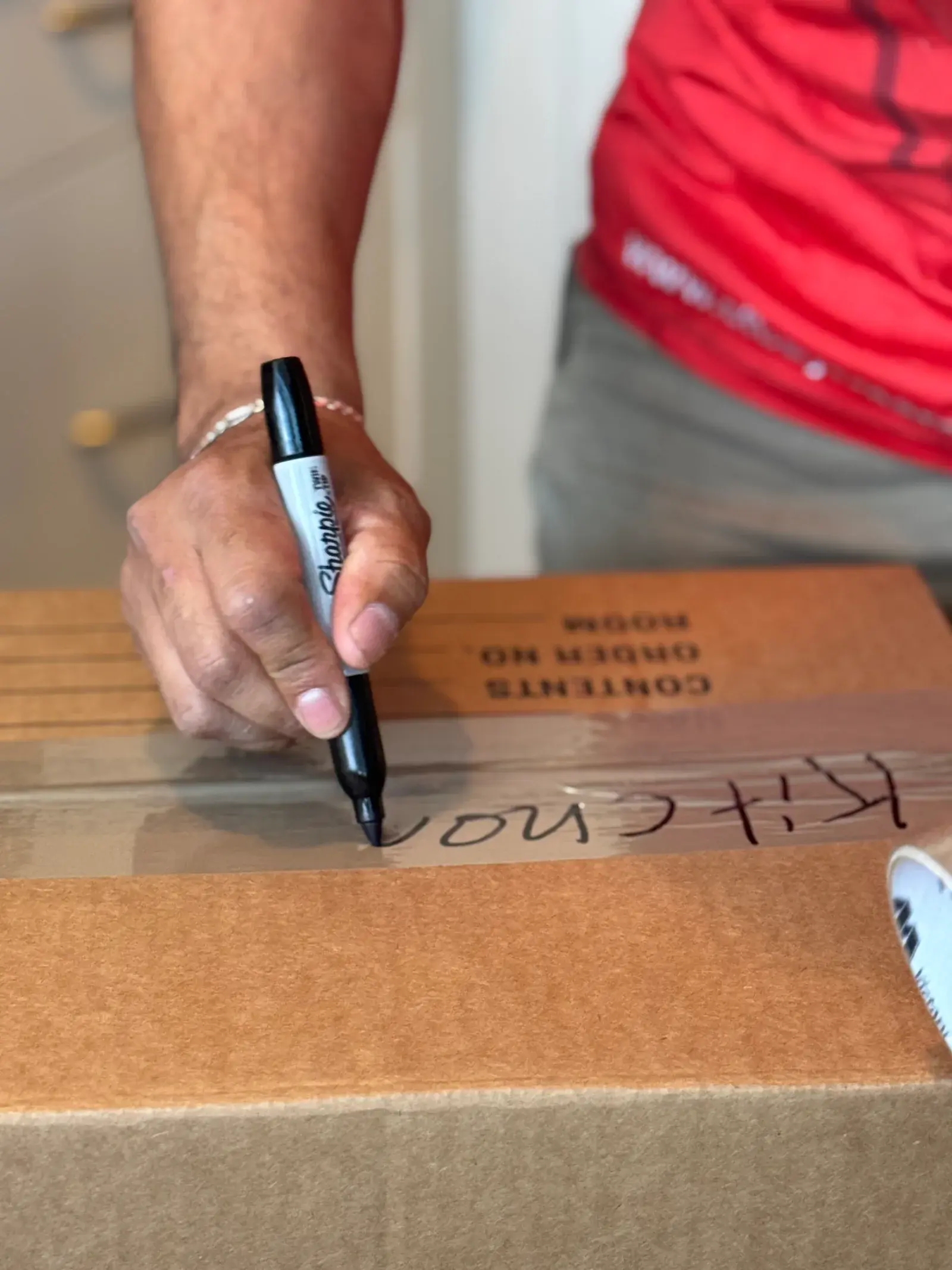 Mover labeling a packed moving box