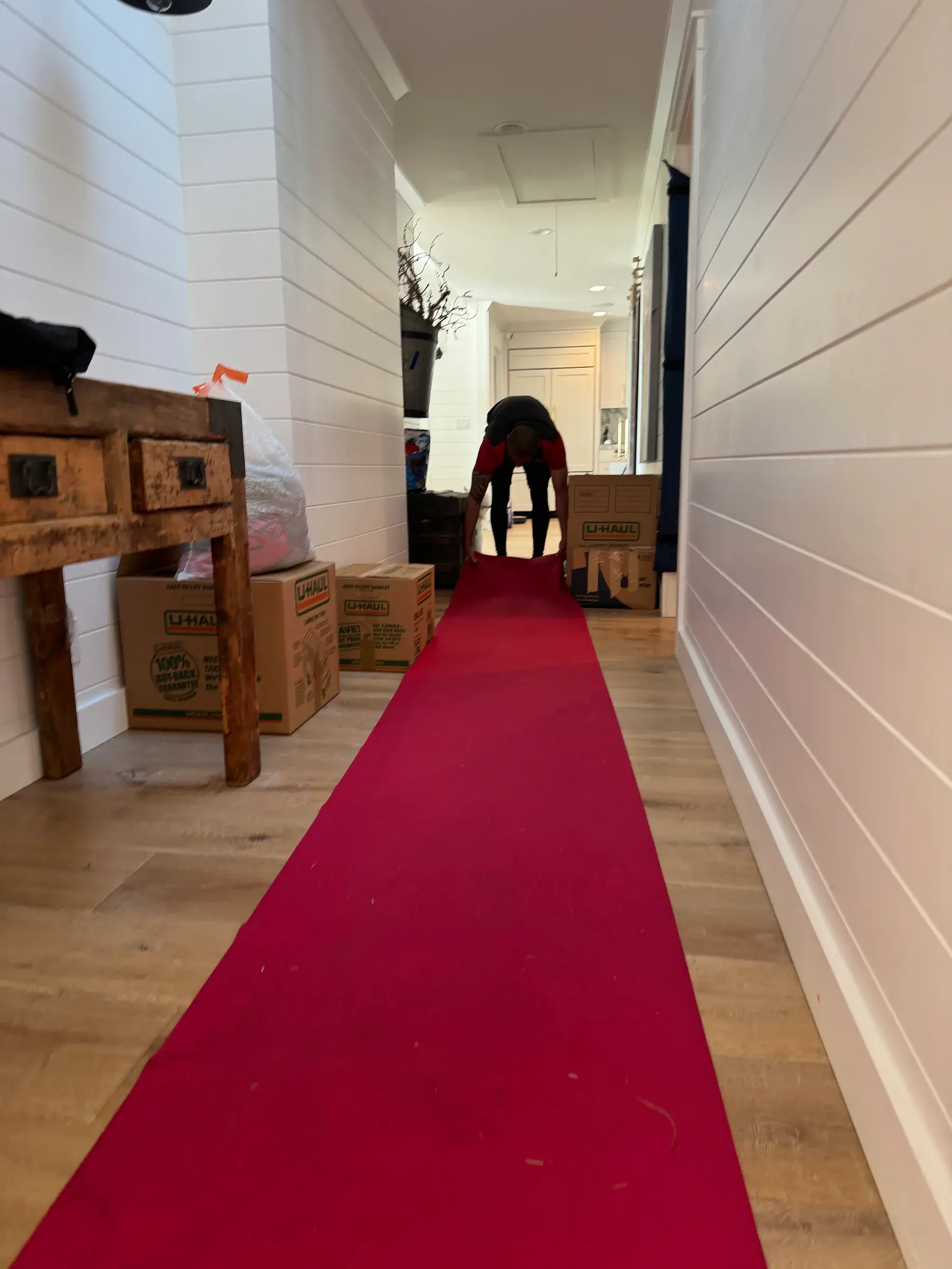 Mover preparing a protected hallway inside a home