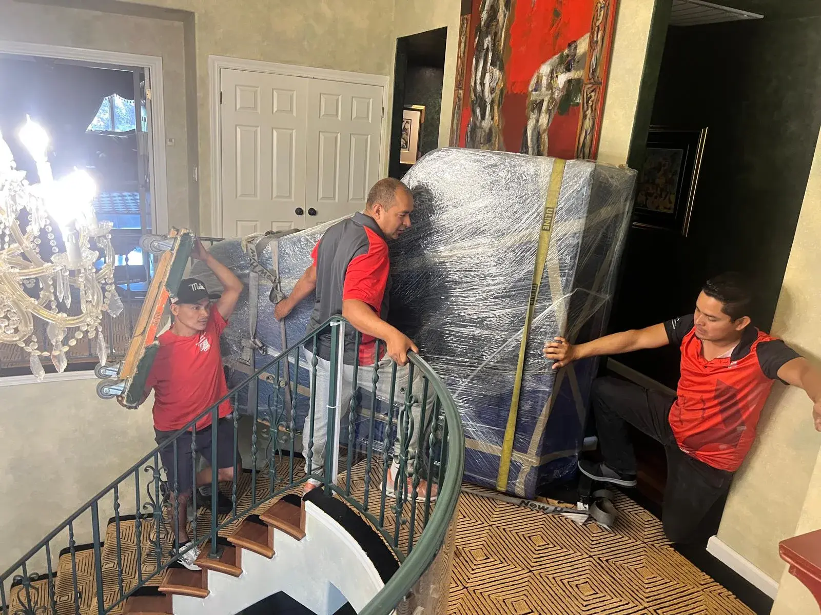 SF Bay Area Moving crew coordinating a protected carry through a staircase