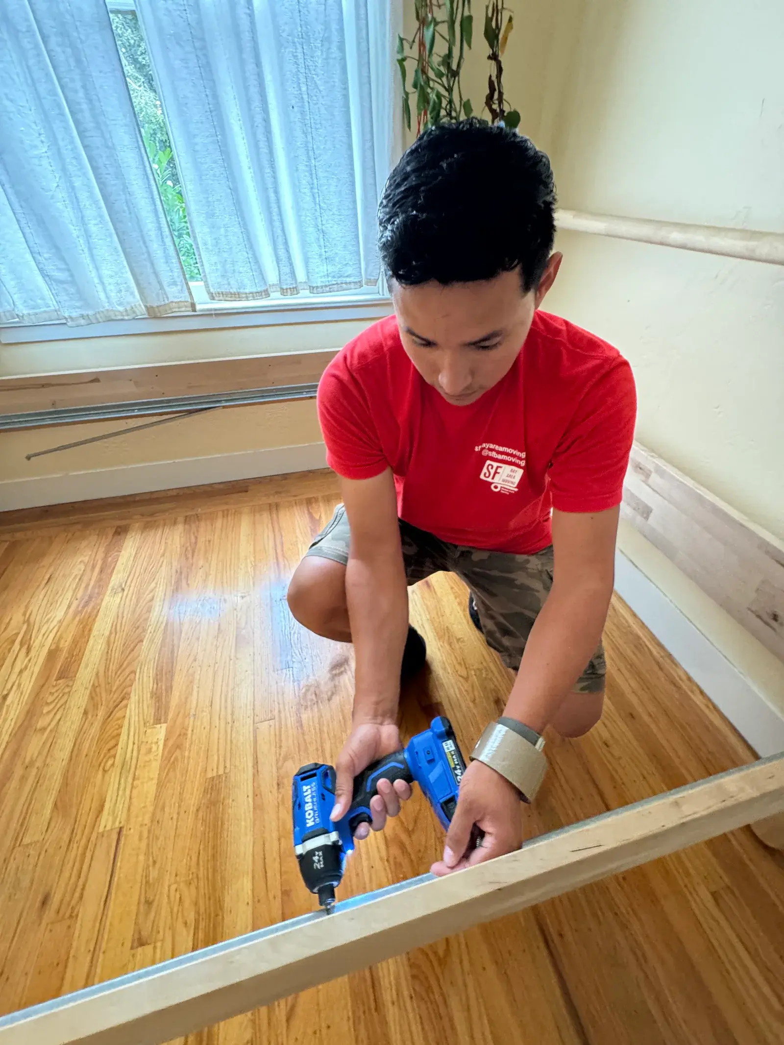 Mover securing floor protection inside a Bay Area home
